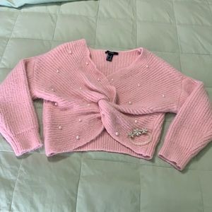 Pink crop top with pearls and bracelet